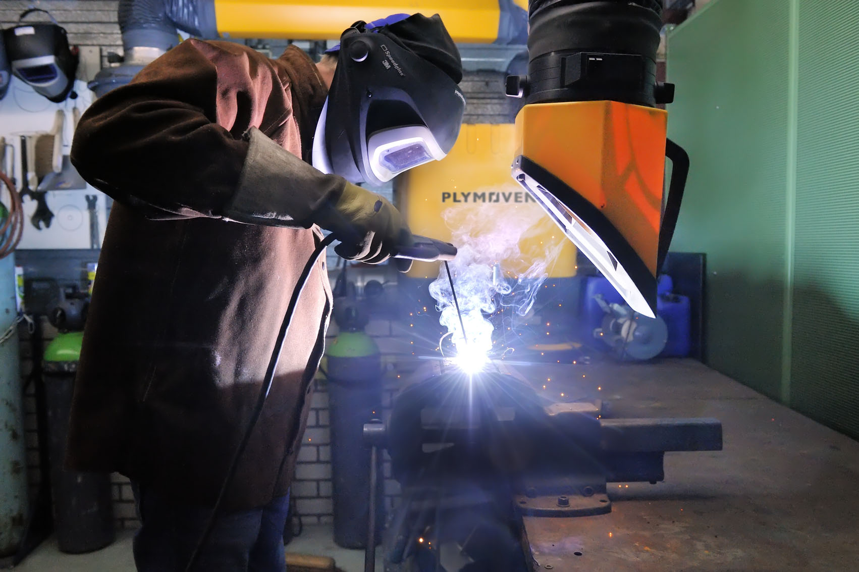 Welding fume extraction arm used in an industrial workshop