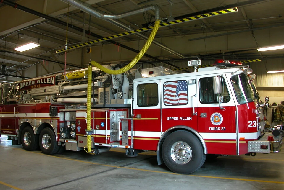 Fire engine in a station bay connected to an overhead Plymovent exhaust extraction hose